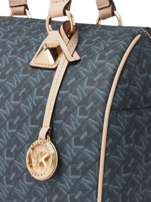 Close-up of a blue patterned bag with beige strap and MK logo charm on a white background monza outlet, Shein outlet, monza fashion