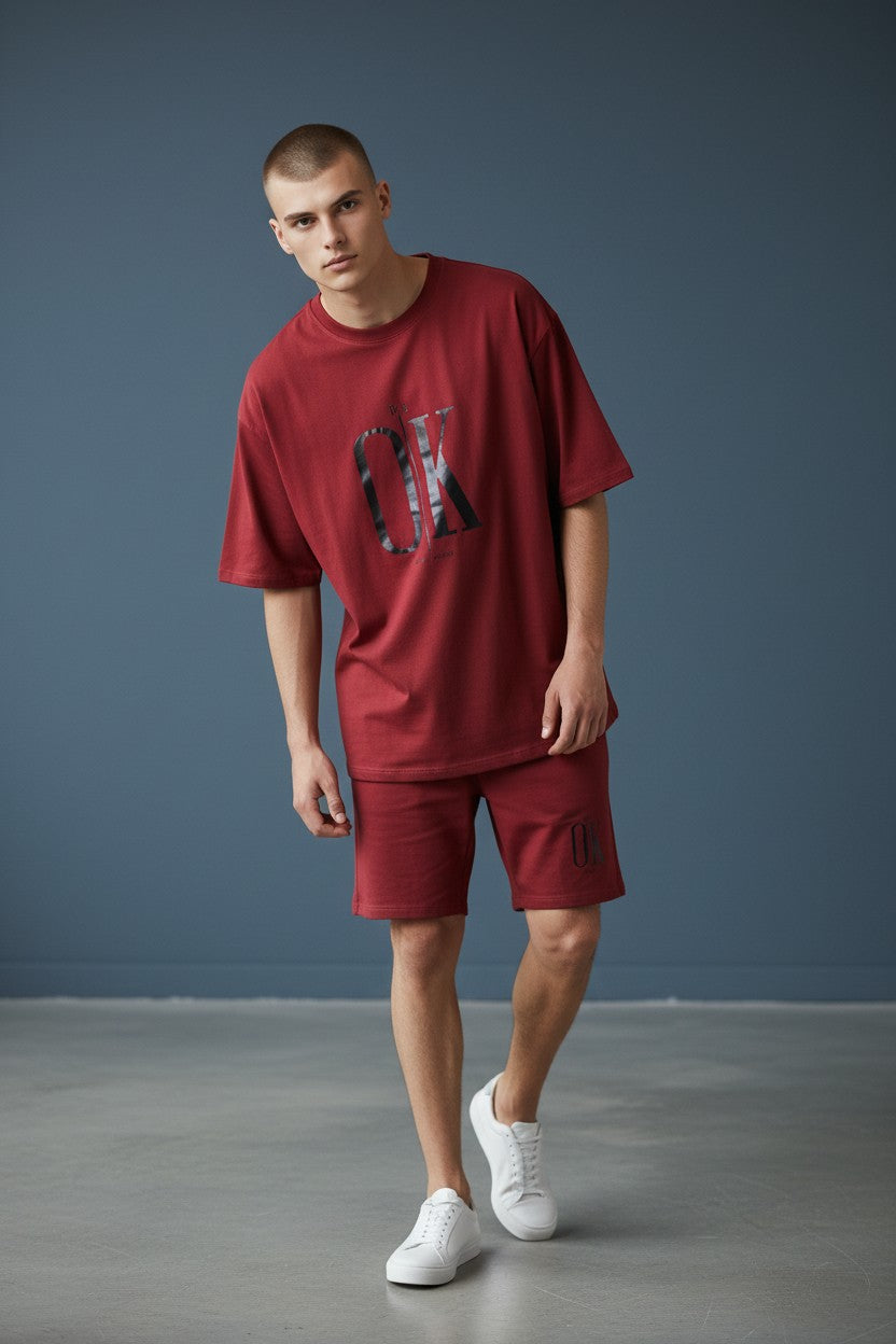 Man wearing a red outfit with a logo against a gray background. Antler, Monza Outlet, Monza Fashion, Shein Outlet