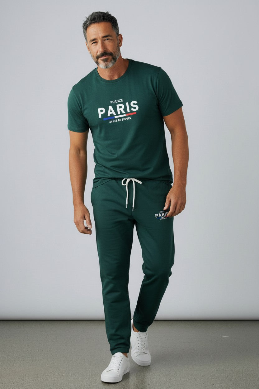 Man wearing a green Paris t-shirt and pants with white sneakers on a plain background. Antler, Monza Outlet, Monza Fashion, Shein Outlet