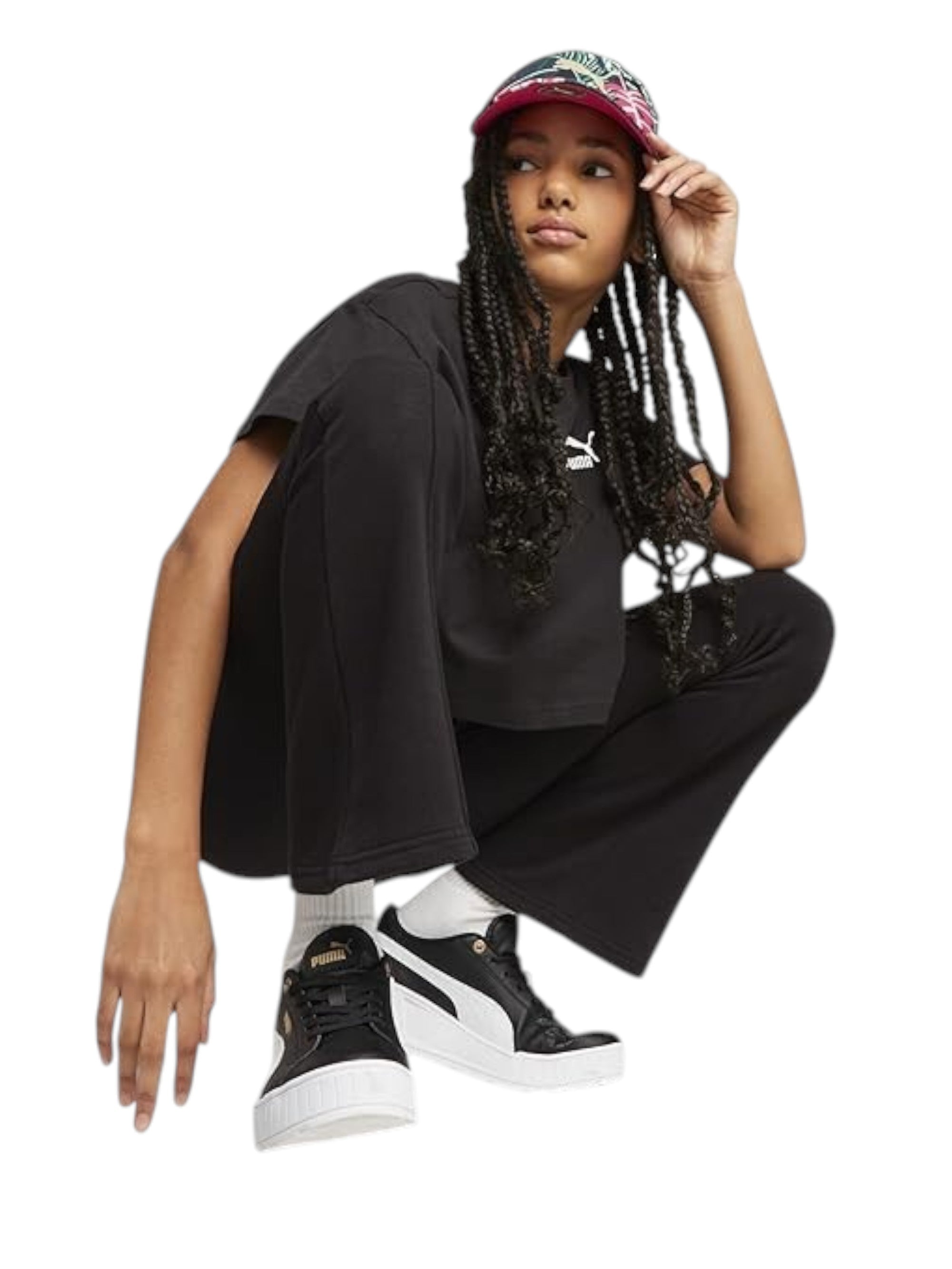 Person wearing black Puma shoes and a black t-shirt with a white logo on a white background Puma Monza Outlet