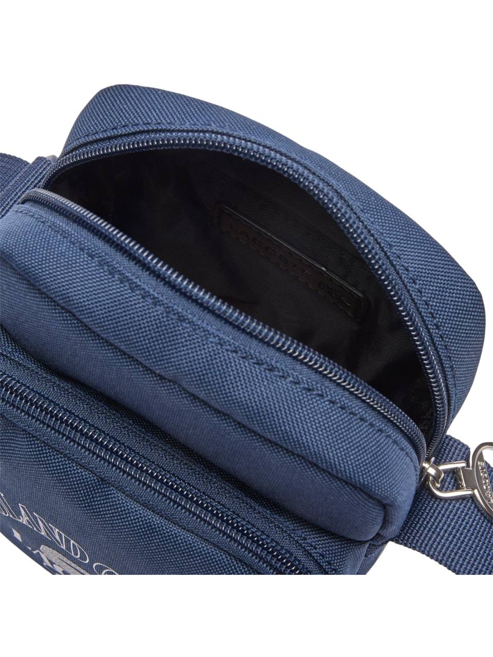 Close-up of a blue bag with a visible brand logo on a white background Lacoste Monza Outlet, Monza Fashion, Shein Outlet