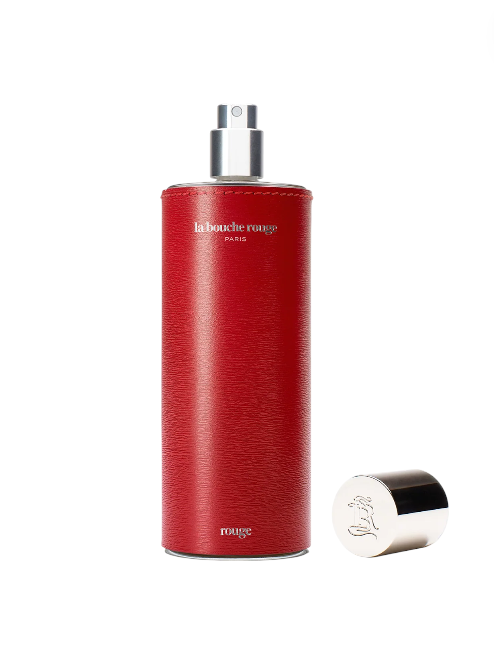Red cylindrical perfume bottle with silver cap on a white background