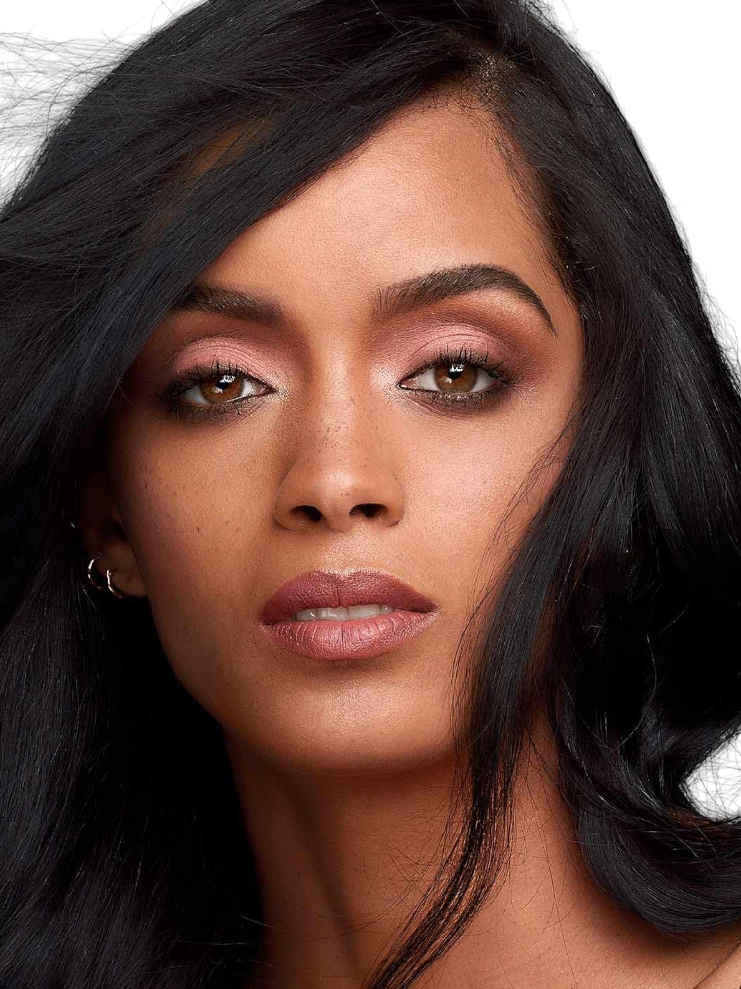 Close-up of a person with dark hair and neutral makeup on a white background Maybelline Monza Outlet