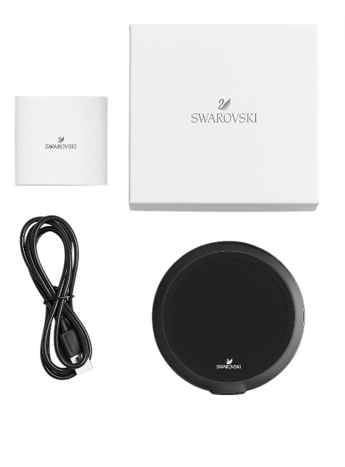 Black Swarovski charging pad with cable and box on a white background. Swarovski Monza Outlet