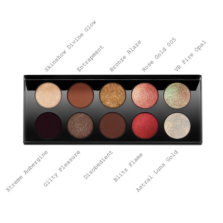 A palette of ten eyeshadows with a variety of finishes including matte, shimmer, and metallic, with shades named Skinshow Divine Glow, Entrapment, Bronze Blaze, Rose Gold 005, VR Fire Opal, Xtreme Aubergine, Gilty Pleasure, Disobedient, Blitz Flame, and Astral Luna Gold. Monza Outlet