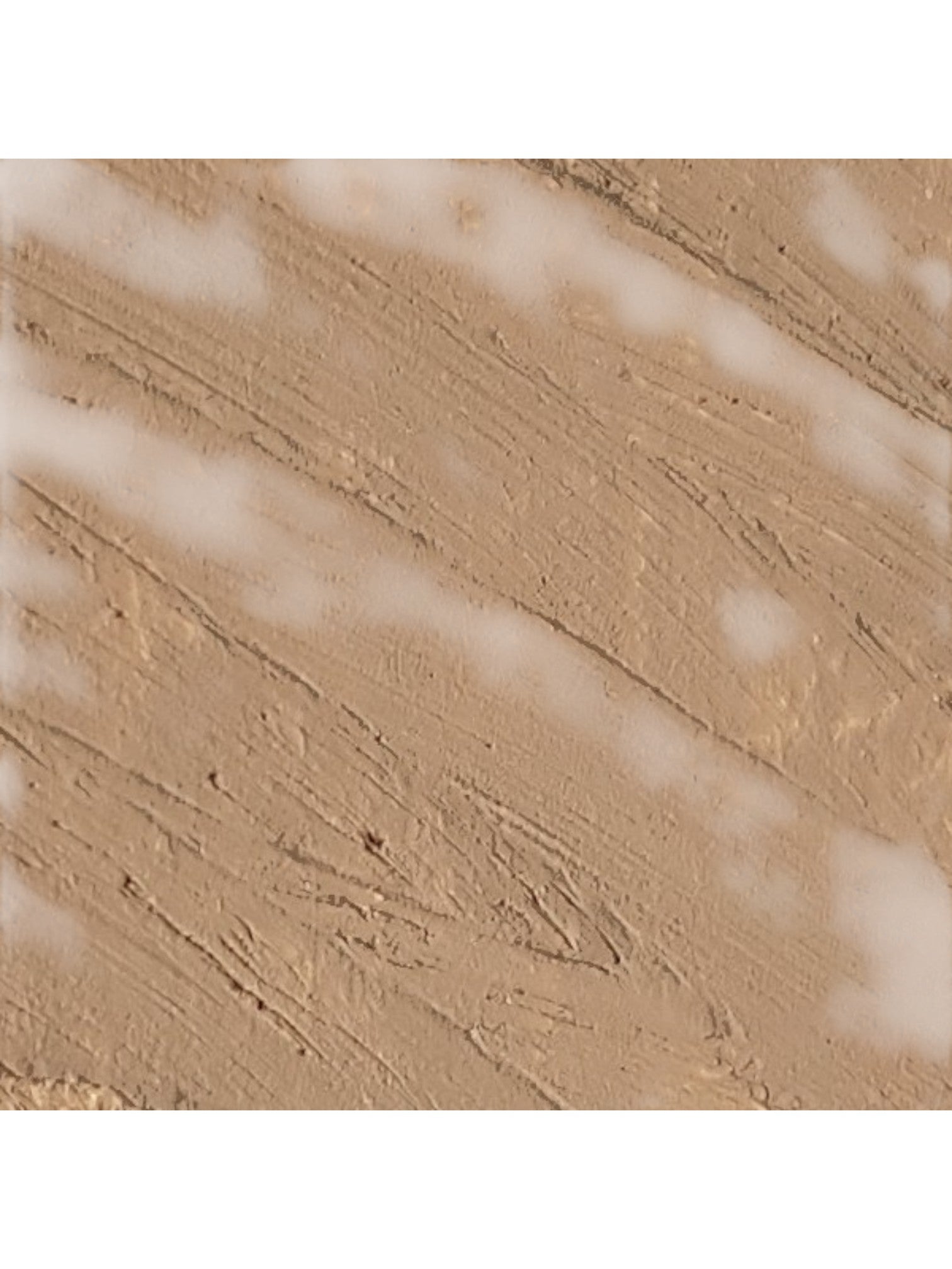 Close-up of beige paint texture with a white background. Isadora, Monza Outlet, Monza Fashion, Shein Outlet