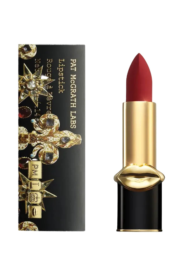 Pat McGrath Labs MatteTrance Lipstick shade Vendetta, a deep crimson red matte lipstick with a blue undertone, presented in elegant black and gold bullet packaging with the signature gold lips design. Monza Outlet