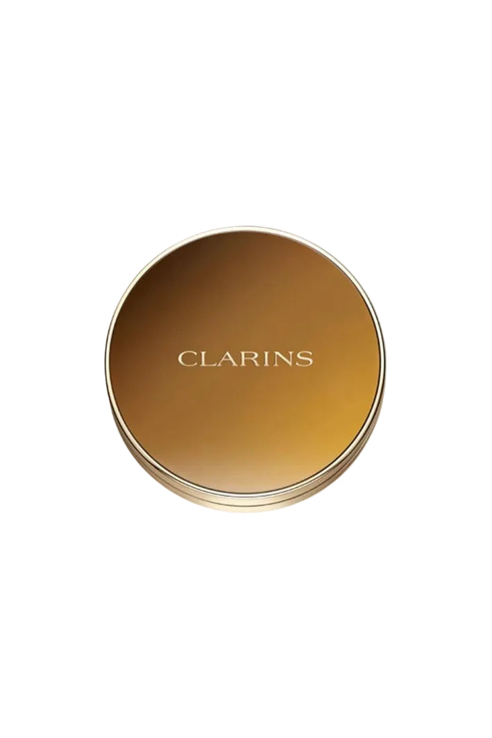 Gold compact with 'Clarins' branding on a white background monza outlet, Shein outlet, monza fashion