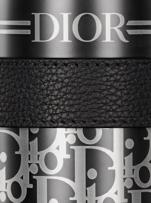 Close-up of a Dior belt with logo design on black leather strap. Monza Outlet