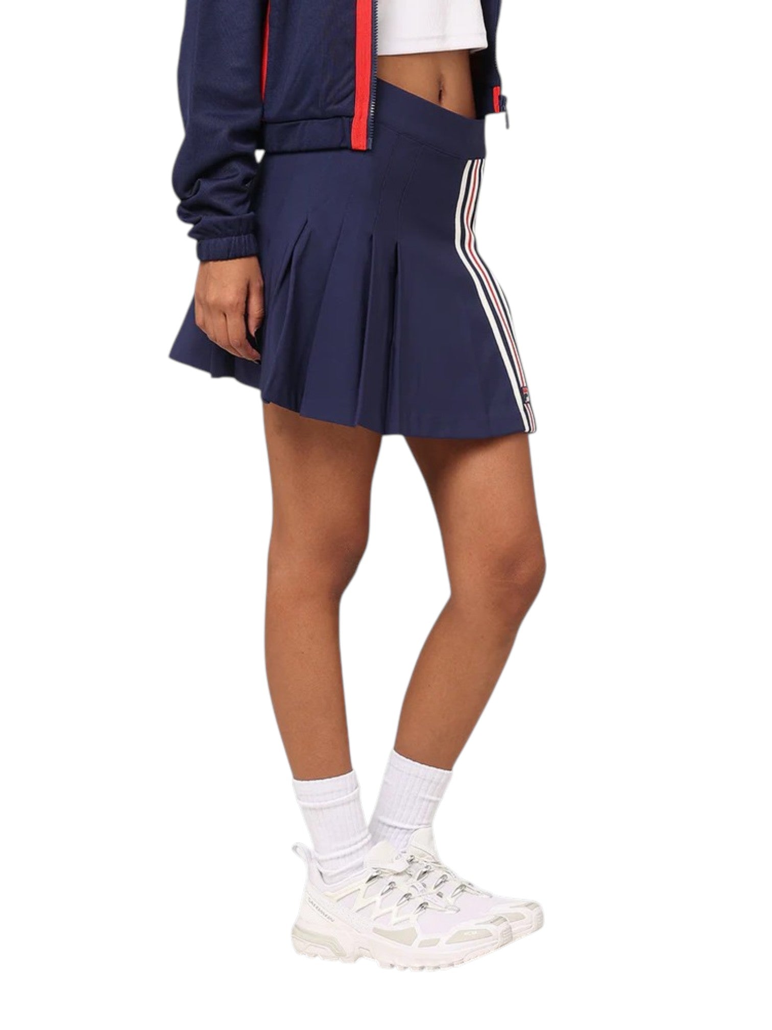 Navy tennis skirt with white stripes worn by a person on a white background. Fila, Monza Outlet, Monza Fashion, Shein Outlet