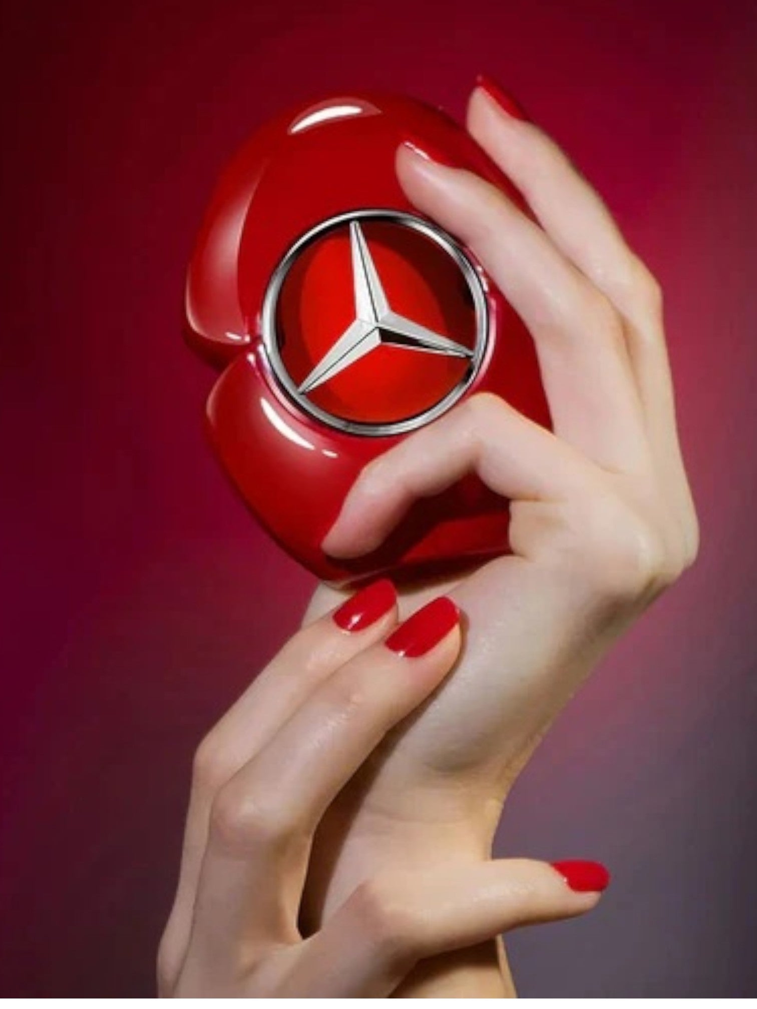 Red perfume bottle with Mercedes-Benz logo held by a hand against a red background. Mercedes-Benz, Monza Outlet, Monza Fashion, Shein Outlet