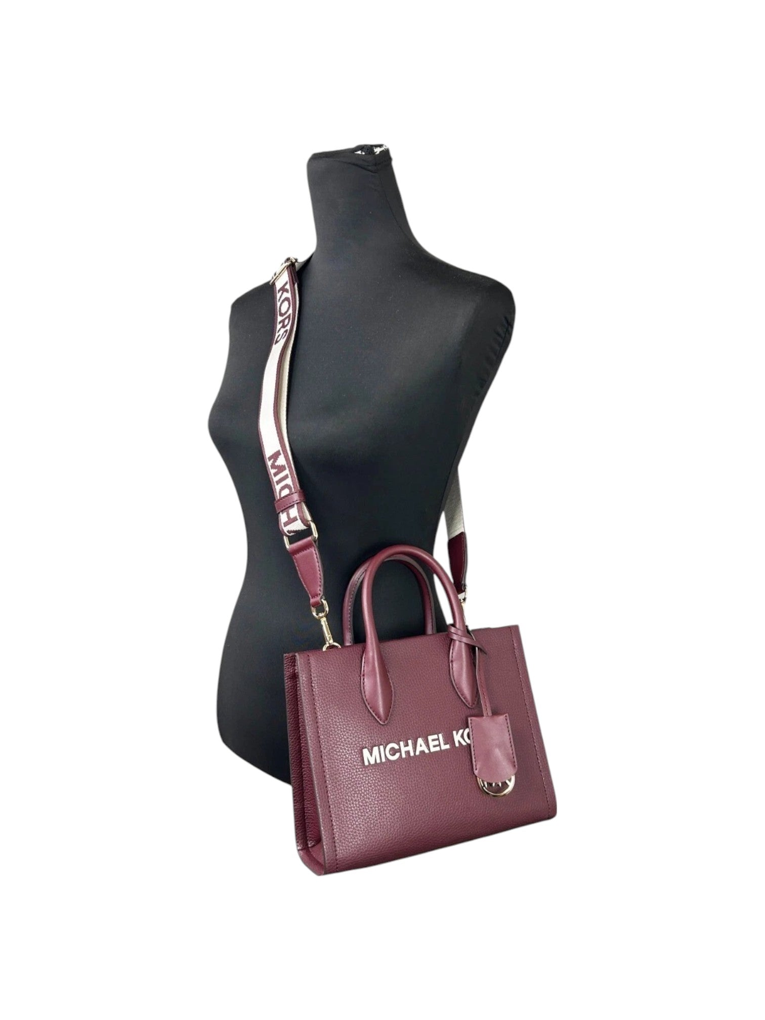 Maroon handbag with Michael K logo on a mannequin against a white background Michael Kors Monza Outlet