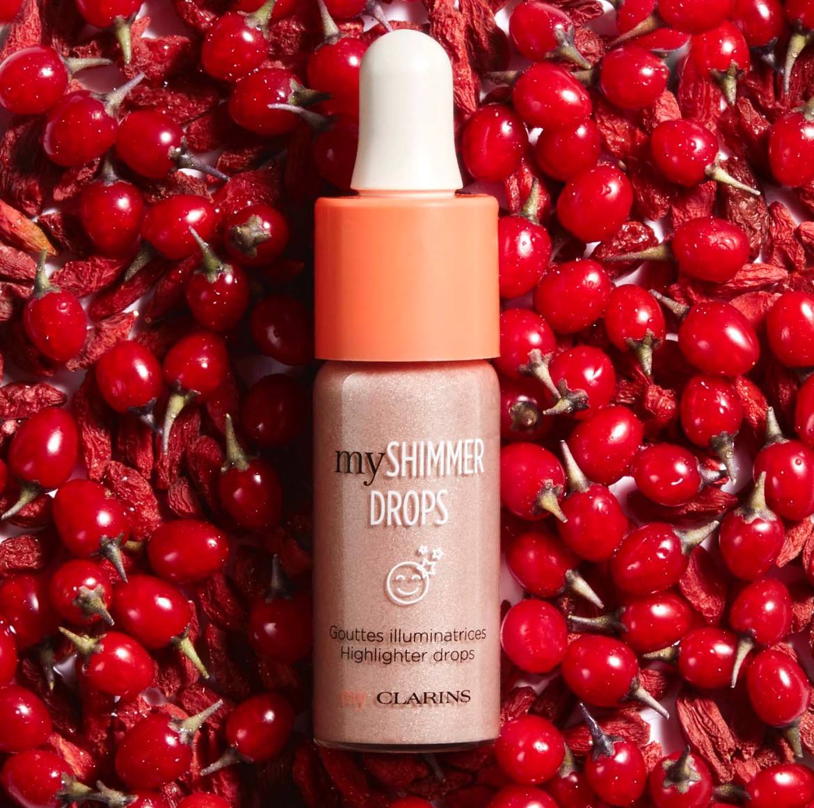 Clarins myShimmer Drops bottle on a red berry background monza outlet, Shein outlet, monza fashion