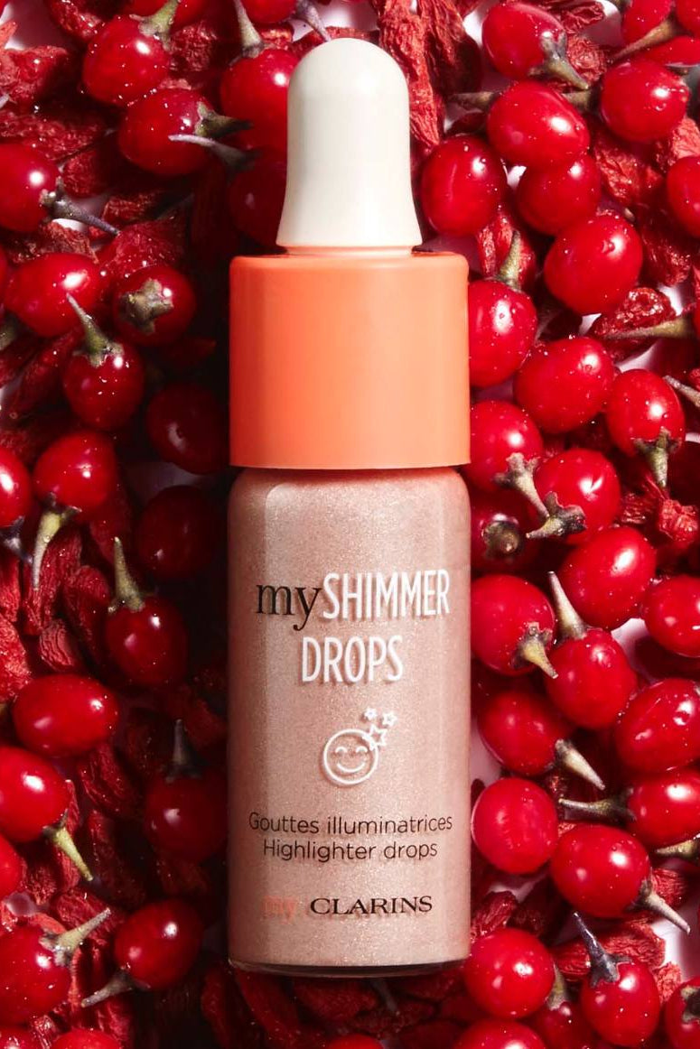 Clarins myShimmer Drops bottle on a red berry background monza outlet, Shein outlet, monza fashion