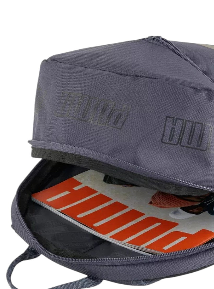 Gray backpack with Puma branding, showing open front compartment revealing orange and white interior. Puma, Monza Outlet, Monza Fashion, Shein Outlet