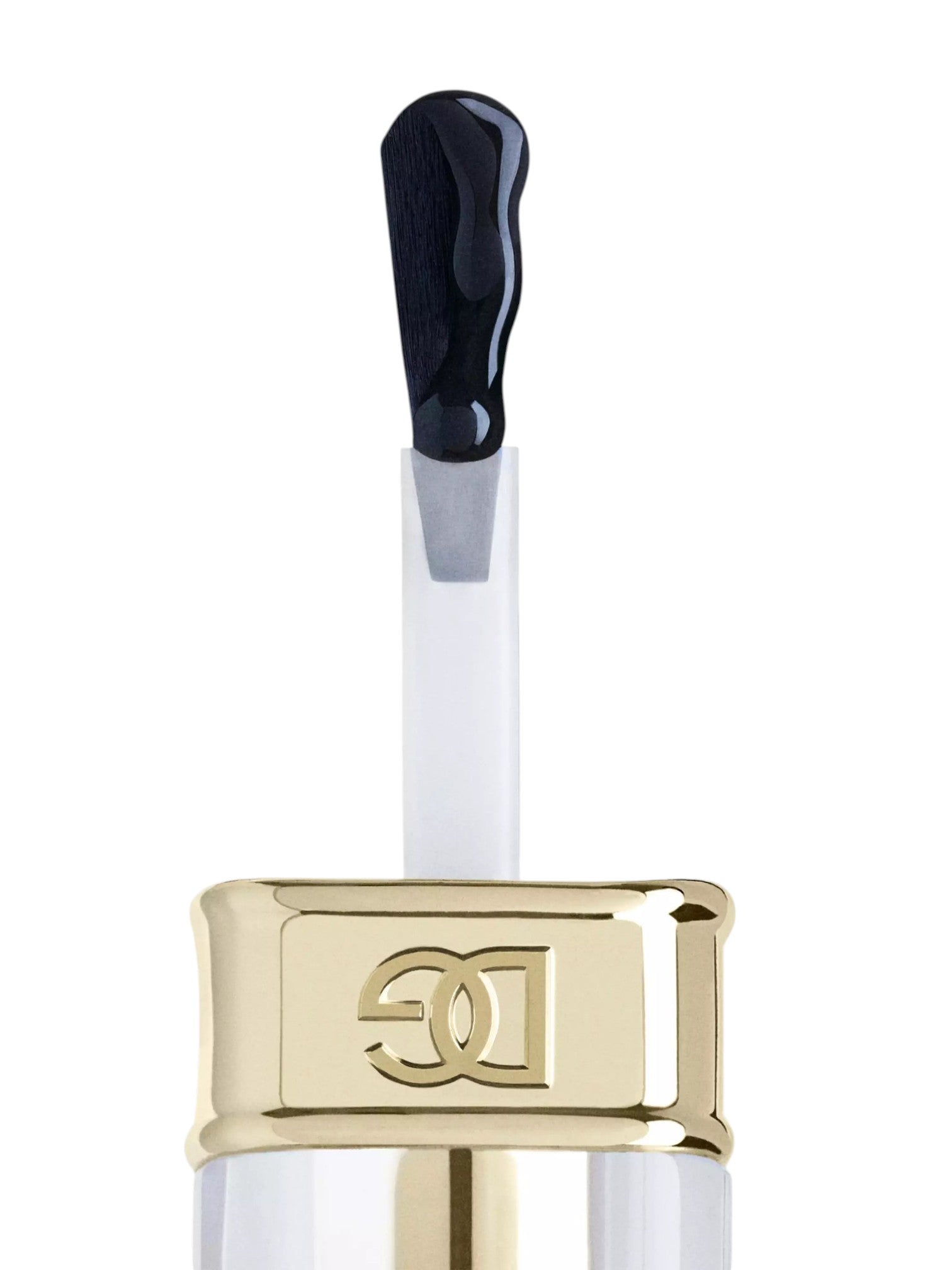 A close up of a cosmetic applicator with a glossy black brush tip, a clear tube, and a shiny gold cap featuring an embossed double C logo, set against a plain white background. Dolce and Gabanna, Monza Outlet, Monza Fashion, Shein Outlet