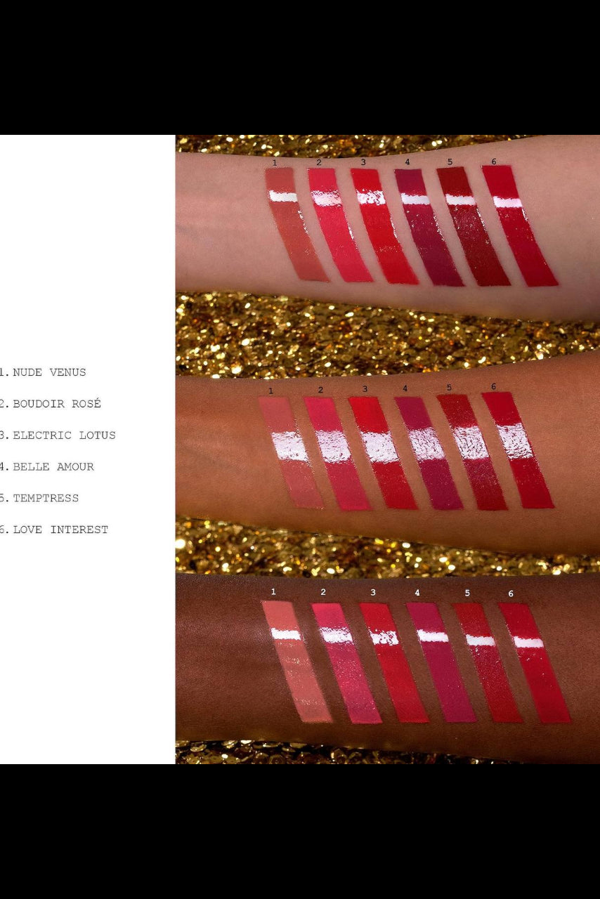 Swatches of lipsticks on a person's arm with gold glitter background Monza Outlet