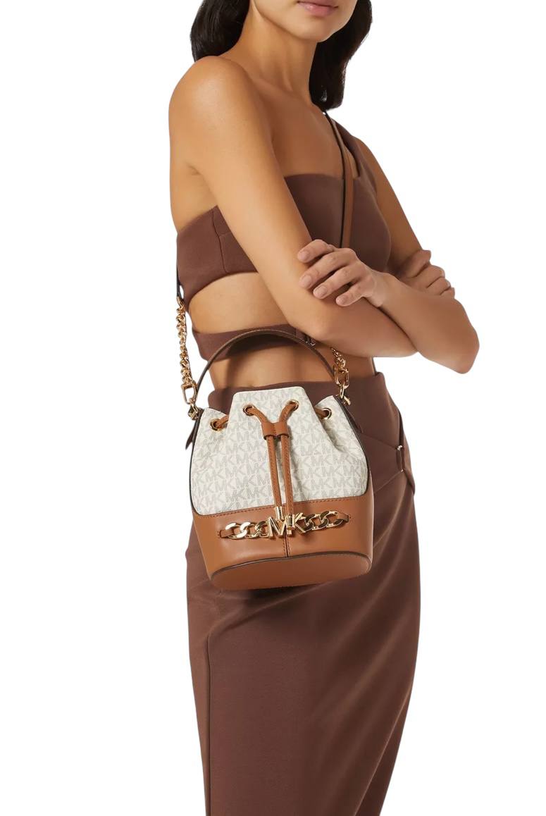 Woman holding a brown and white handbag against a white background, Michael Kors, Monza Outlet, Monza Fashion, Shein Outlet