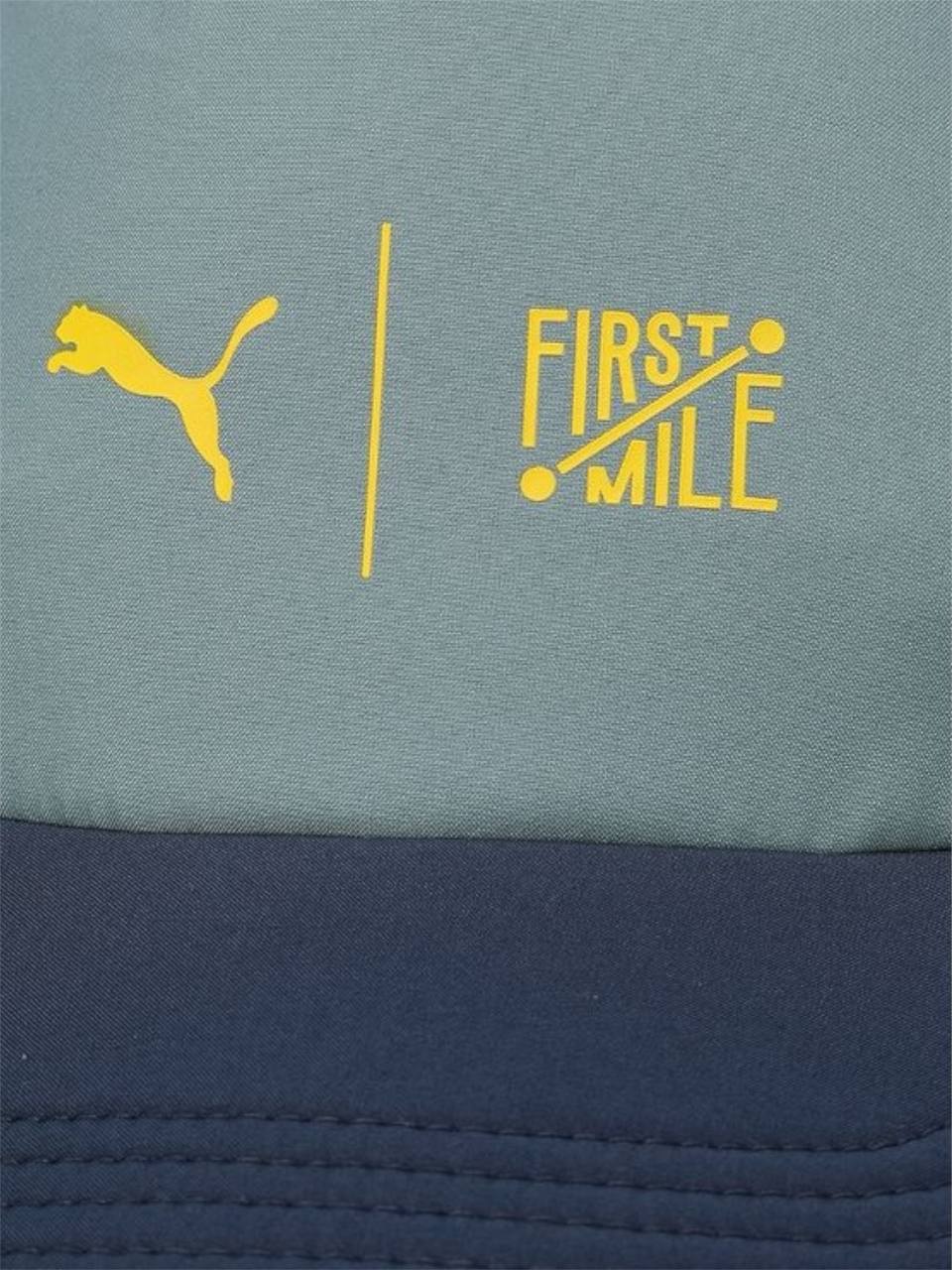 Close-up of Puma and First Mile logos on a product with a blue and gray background. Puma Monza Outlet