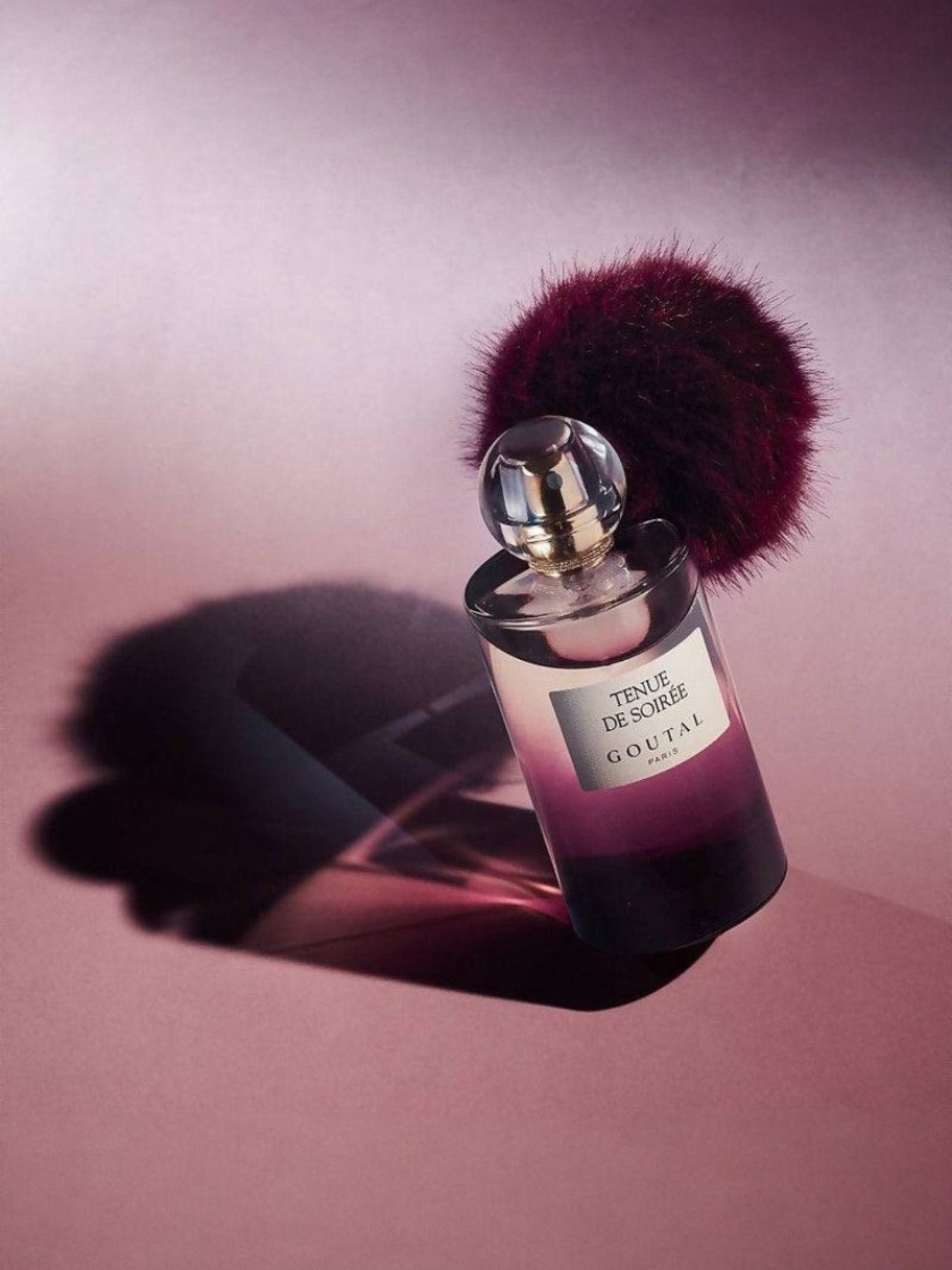 Perfume bottle with a purple cap on a pink background. Goutal, Monza Outlet, Monza Fashion, Shein Outlet