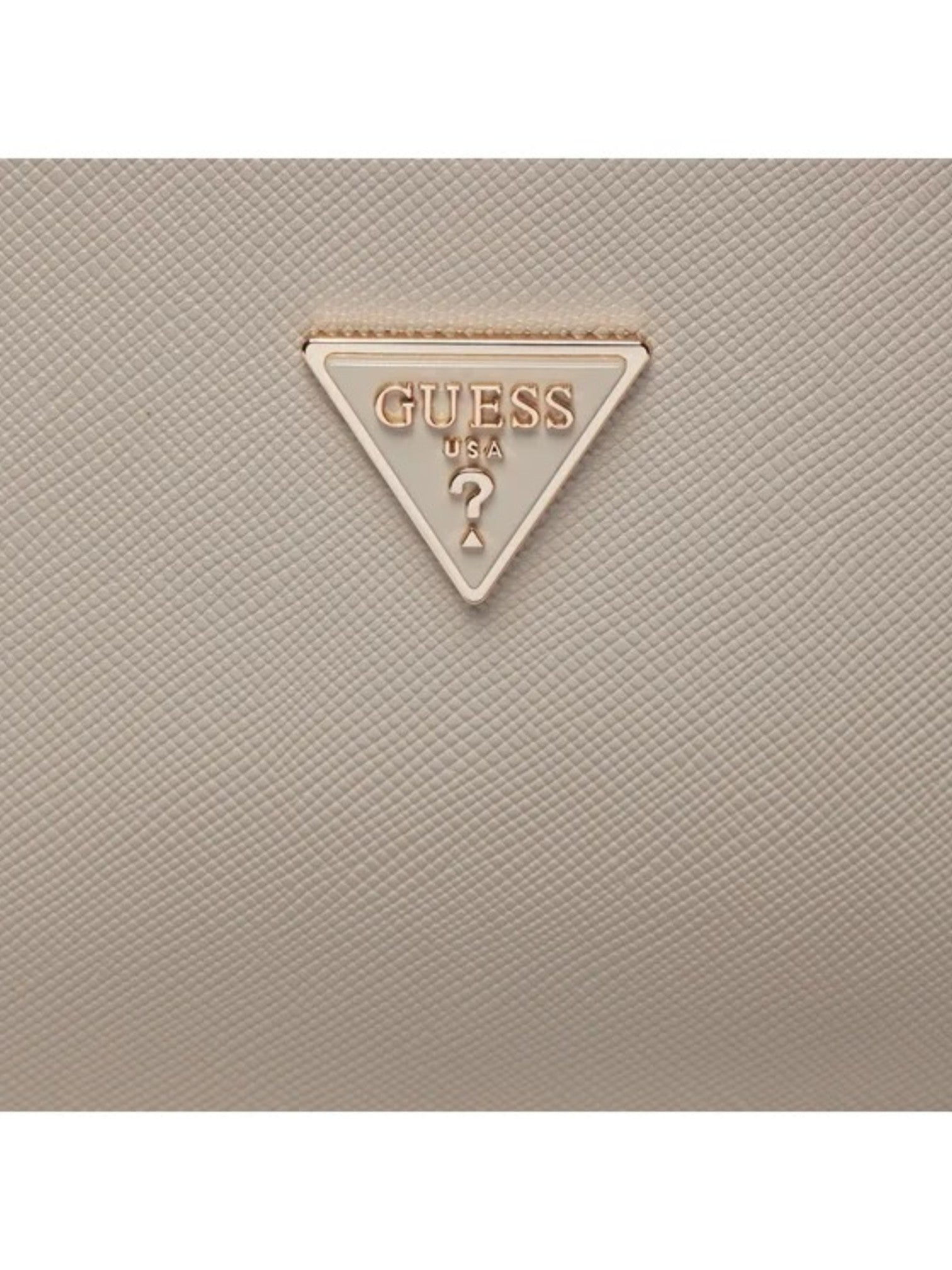 Close-up of a beige textured surface with a Guess logo. Guess, Monza Outlet, Monza Fashion, Shein Outlet