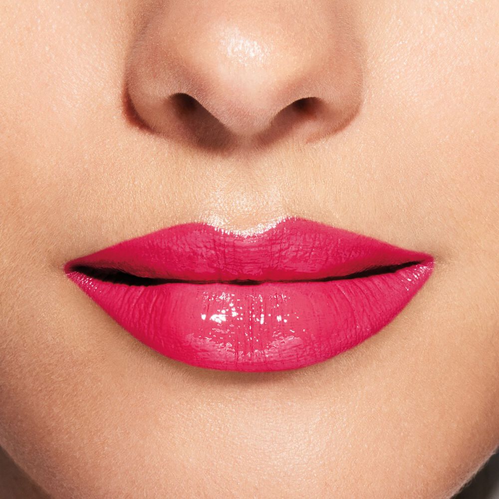 Close-up of a person's lips with bright pink lipstick on a neutral background