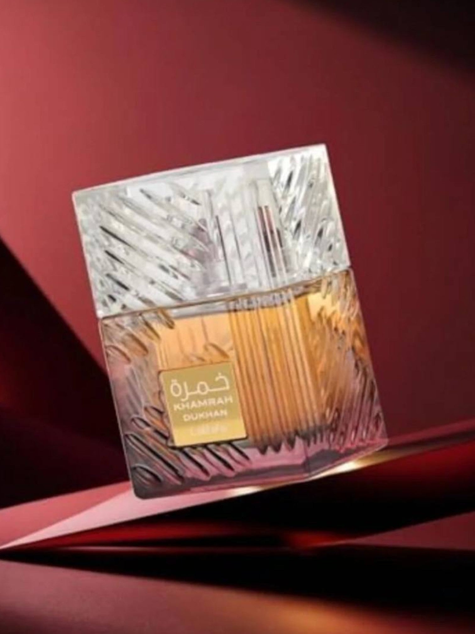 Perfume bottle with decorative packaging on a red background. Lattafa, Monza Outlet, Monza Fashion, Shein Outlet
