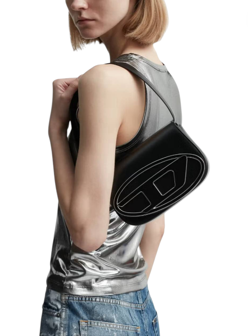 Person wearing a metallic tank top with a black pouch over one shoulder on a white background monza outlet, Shein outlet, monza fashion