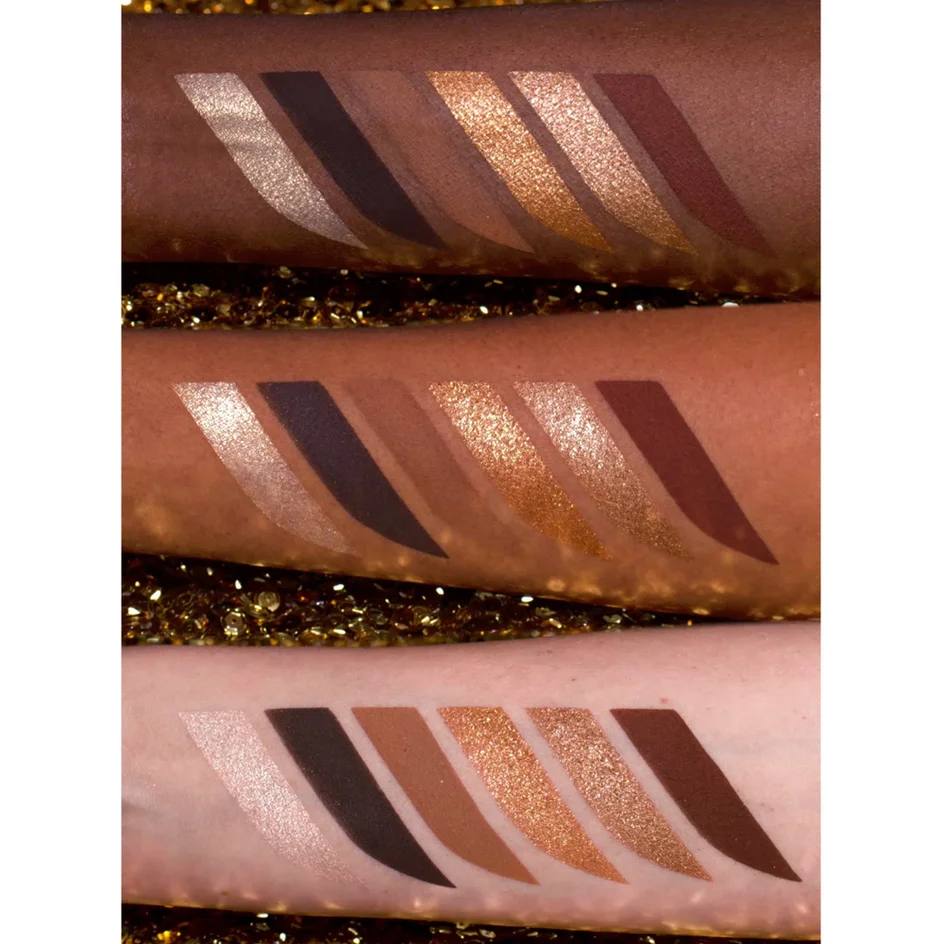 Close-up of makeup swatches on skin with glitter background Monza Outlet