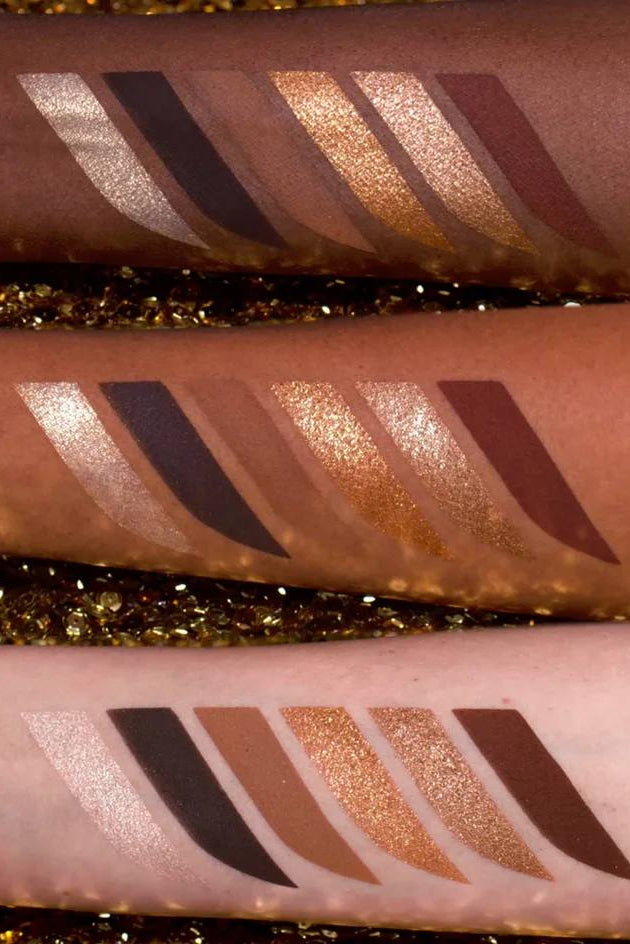 Close-up of makeup swatches on skin with glitter background Monza Outlet