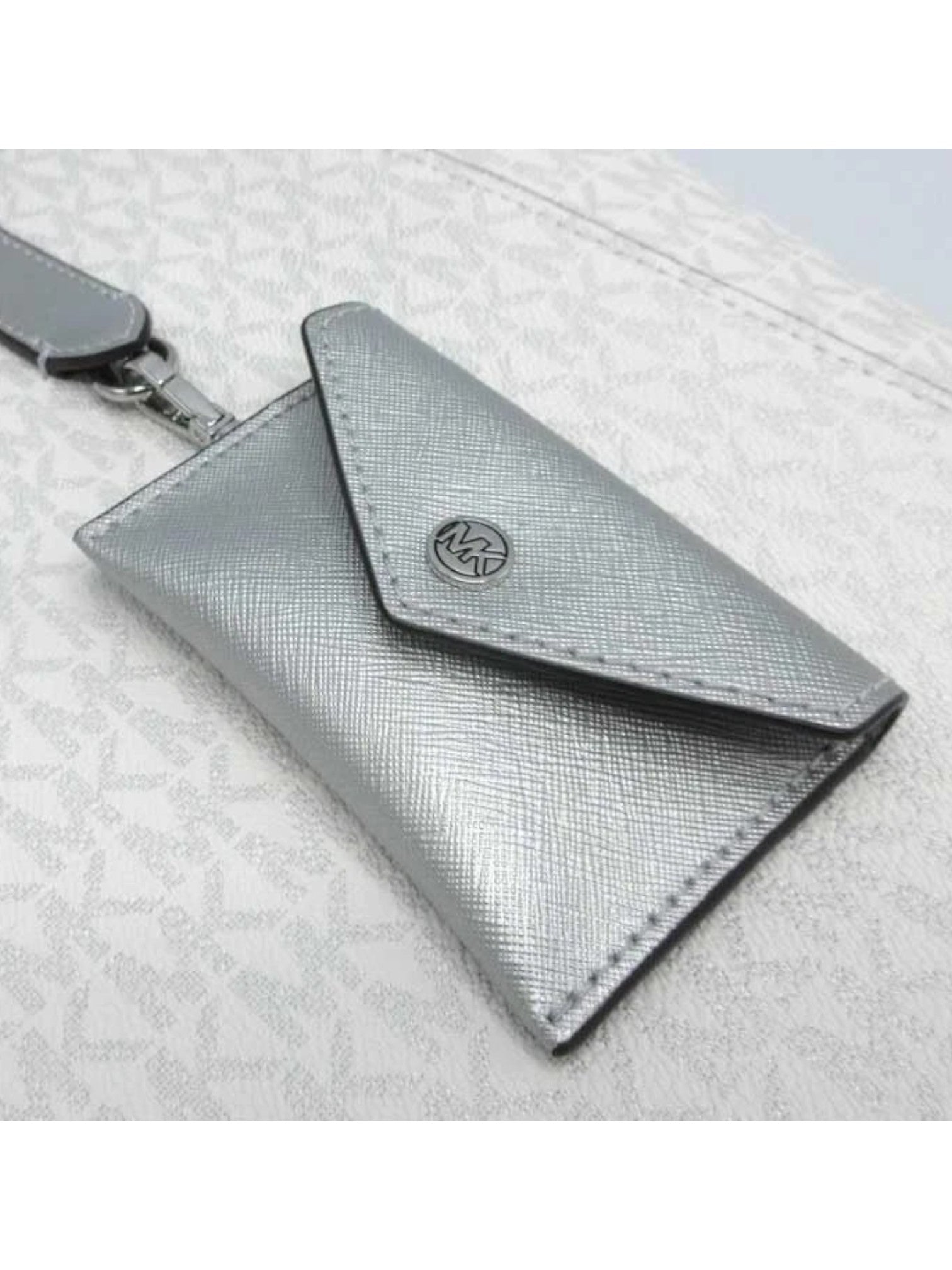 Silver wallet with a strap on a light gray background Michael Kors Monza Outlet