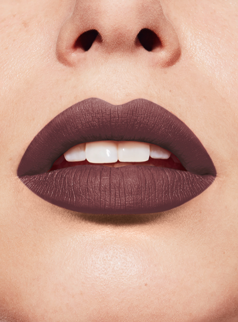 Close-up of a person's lips wearing a dark purple lipstick. Bourjois Monza Outlet