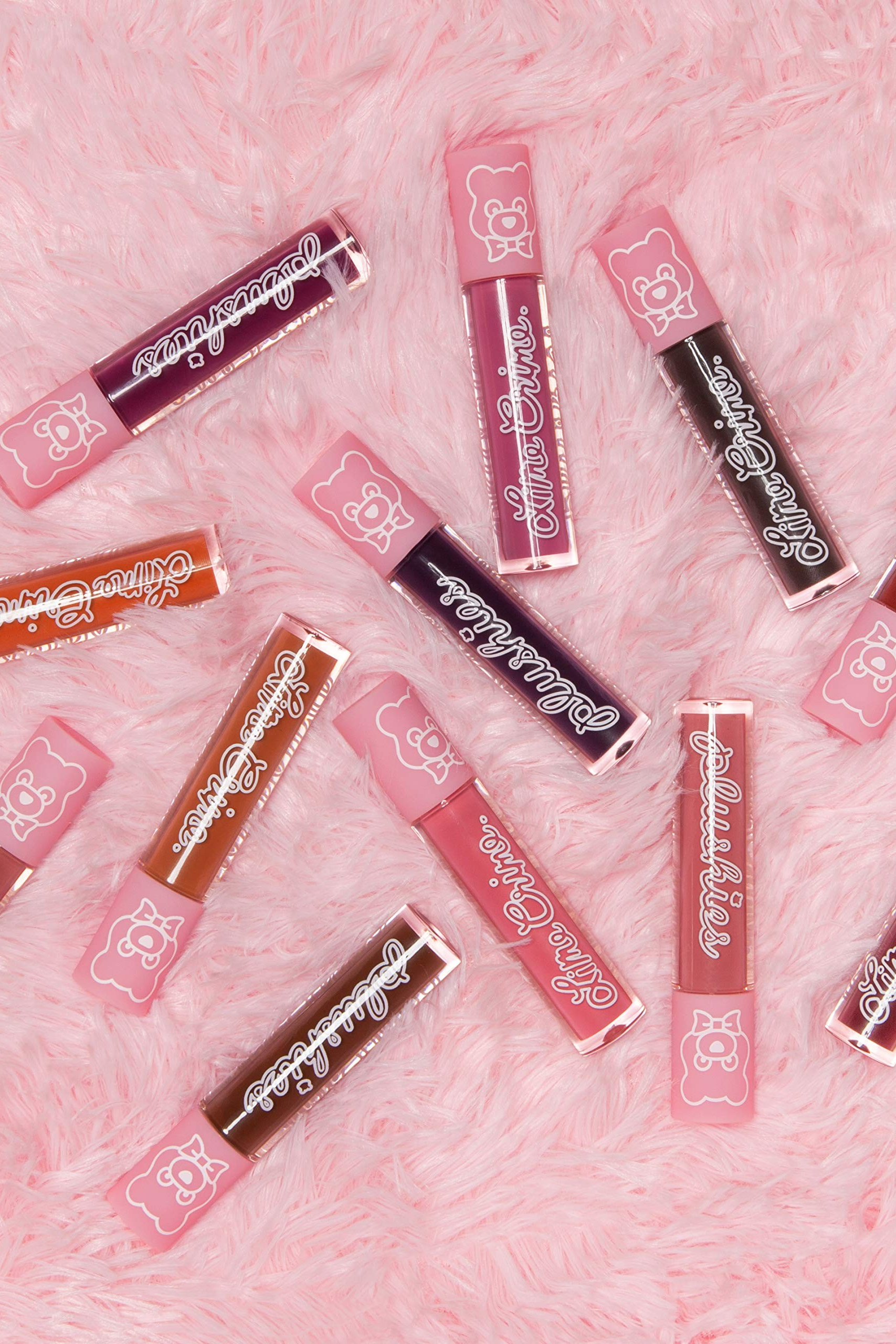 Collection of lip glosses on a pink textured background Monza fashion outlet, monza outlet, shein outlet, shien outlet cosmetics, makeup, perfume