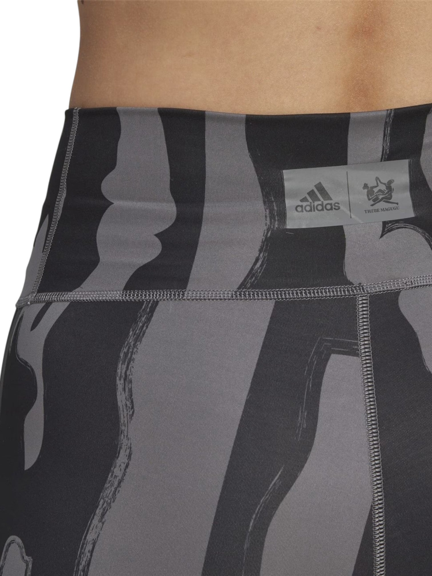 Black and gray patterned athletic shorts with Adidas logo on a white background. Adidas, Monza Outlet, Monza Fashion, Shein Outlet