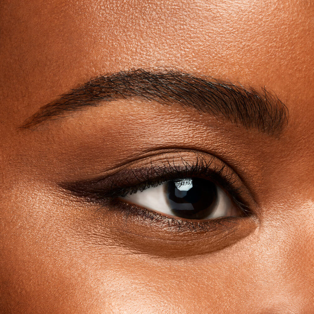 Close-up of a person's eye with dark brown eyeliner and eyebrow. Monza fashion outlet, monza outlet, shein outlet, shien outlet cosmetics, makeup, perfume