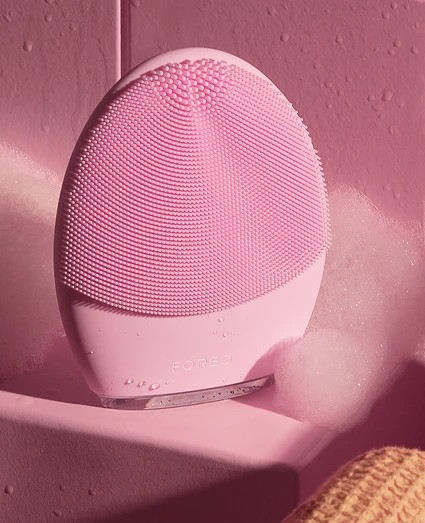 Pink and white electronic device with textured surface on a pink background Monza outlet, monza fashion, shein outlet, shien outlet
