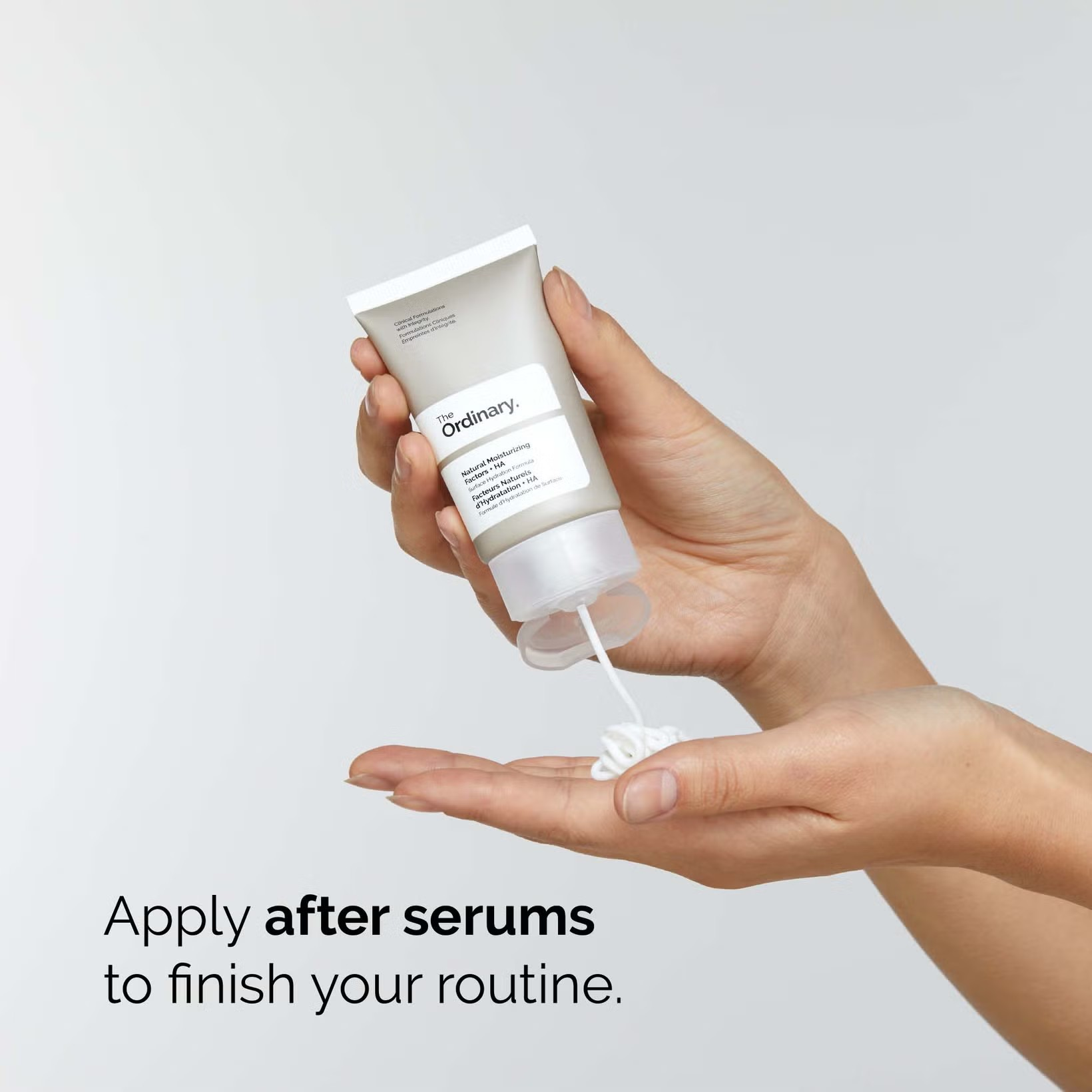 Hand holding a skincare product with text on a gray background Monza fashion outlet, monza outlet, shein outlet, shien outlet cosmetics, makeup, perfume