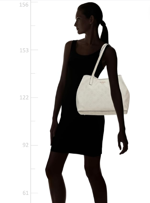 Woman holding a white handbag against a white background. Guess, Monza Outlet, Monza Fashion, Shein Outlet