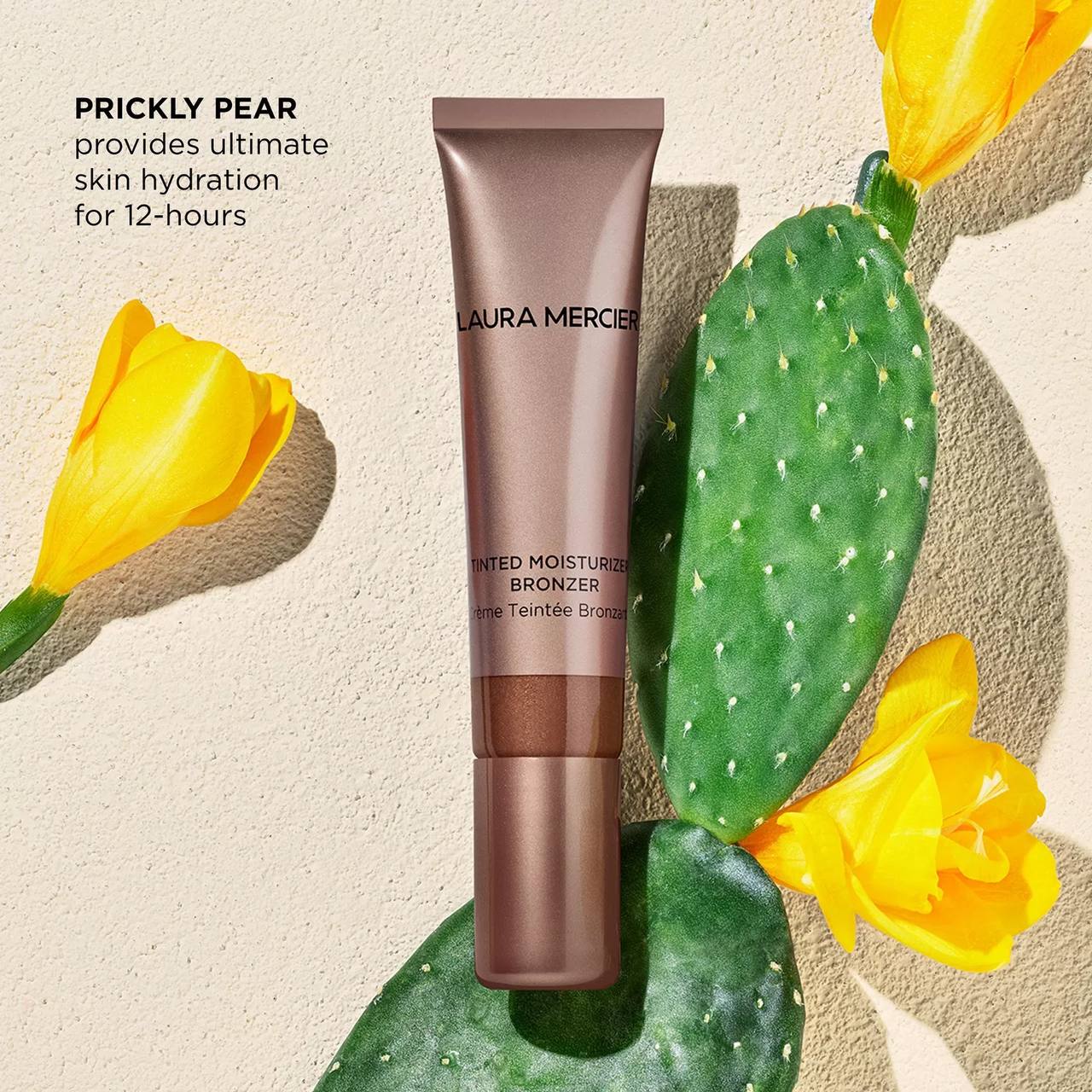 Laura Mercier bronzer tube with prickly pear cactus and yellow flowers on a beige background Laura Mercier Monza Outlet