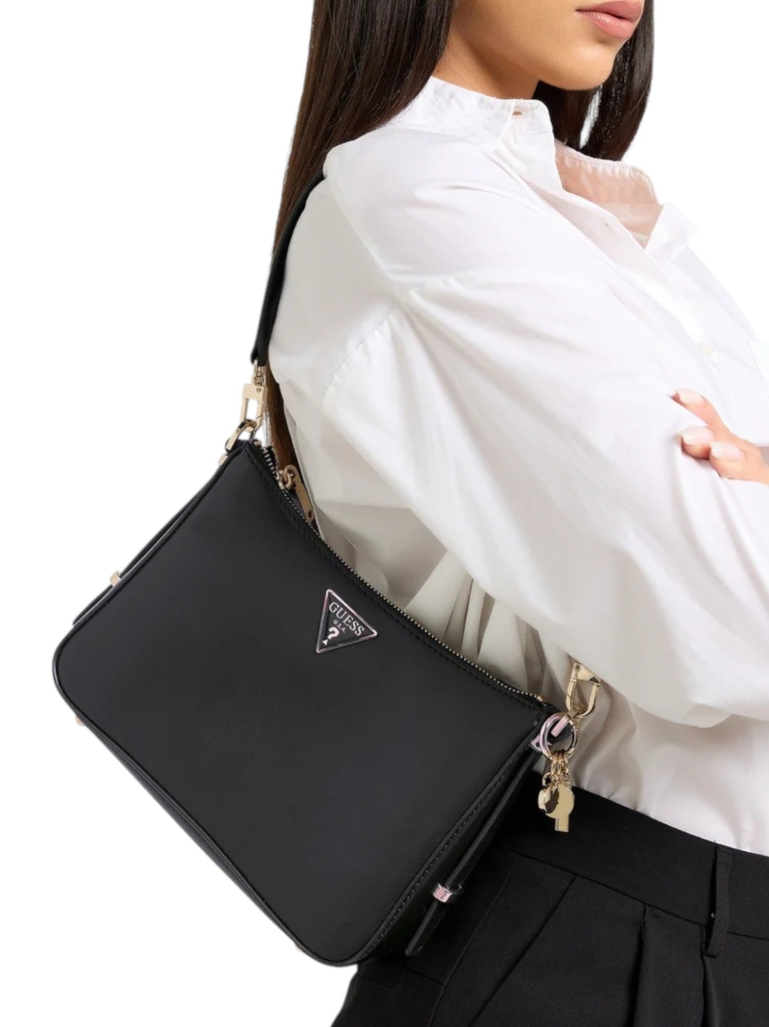 Person wearing a black Prada handbag with a white shirt and black pants. Guess, Monza Outlet, Monza Fashion, Shein Outlet