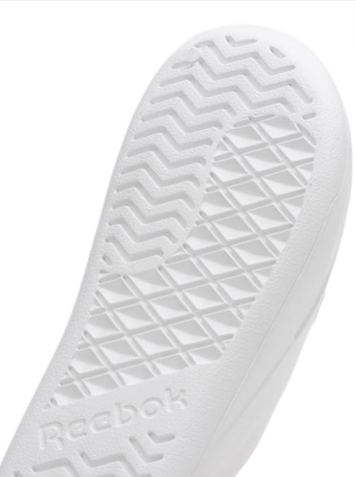 Close-up of a white sneaker sole with Reebok branding on a white background Reebok Monza Outlet