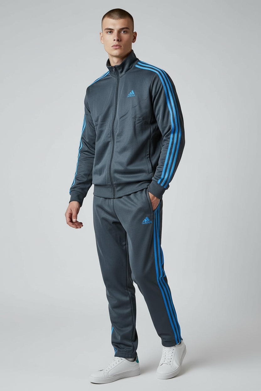 Man wearing a gray Adidas tracksuit with blue stripes on a white background. Adidas, Monza Outlet, Monza Fashion, Shein Outlet