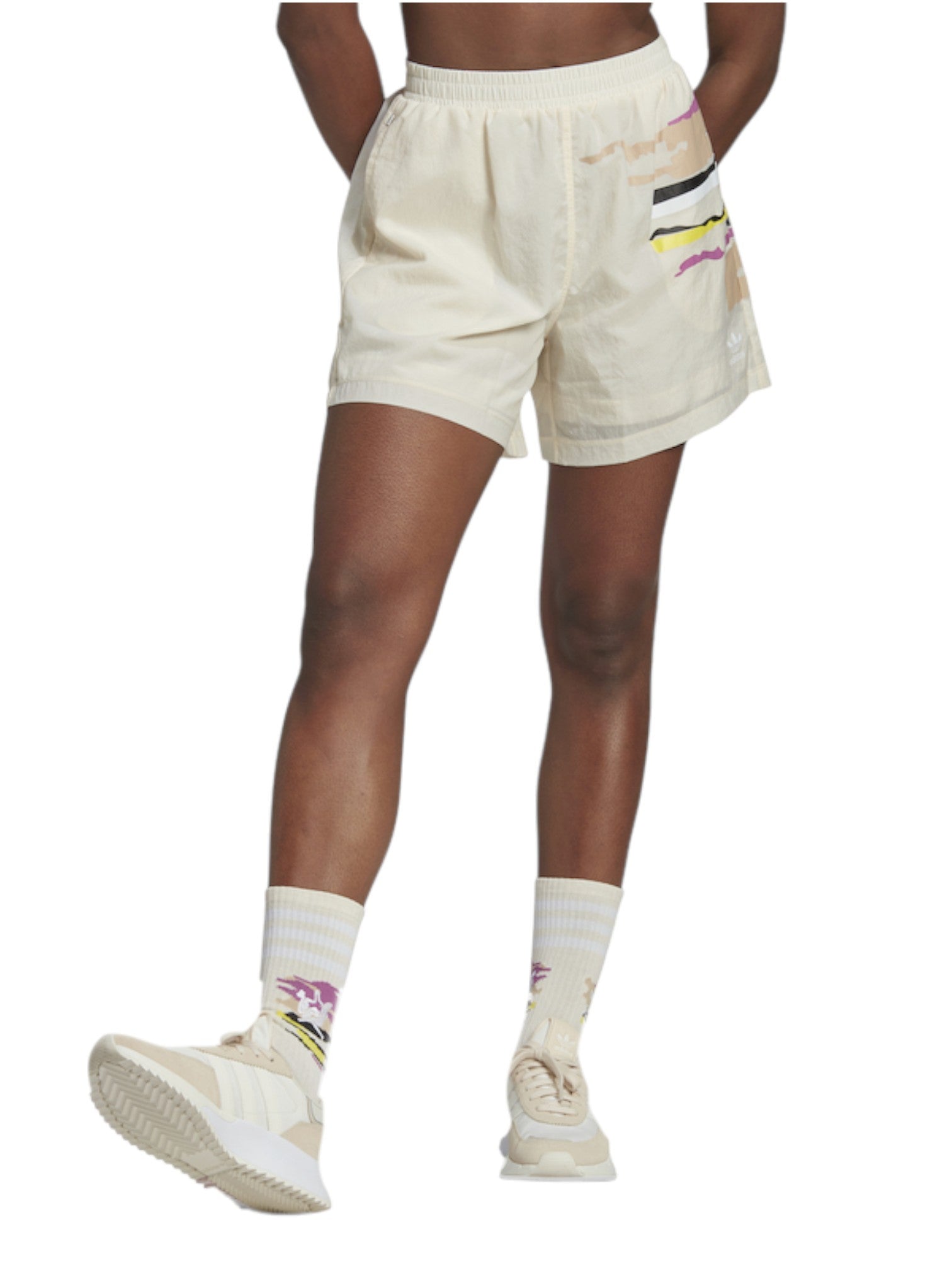 Person wearing cream shorts with colorful patterns on a white background. Adidas, Monza Outlet, Monza Fashion, Shein Outlet