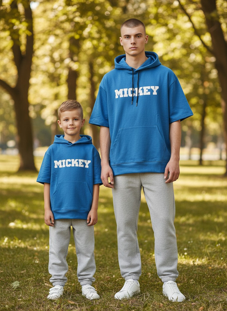 Two people wearing blue 'MICKEY' hoodies standing in a park. Antler, Monza Outlet, Monza Fashion, Shein Outlet 