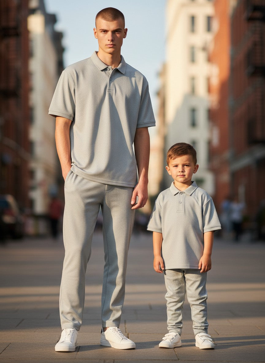 Man and child standing on a city street wearing matching gray outfits. Antler, Monza Outlet, Monza Fashion, Shein Outlet 