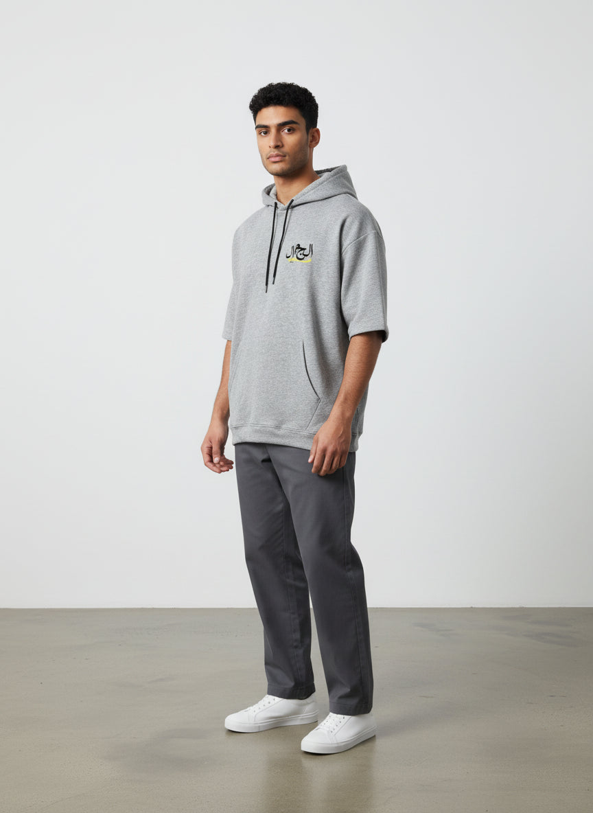 Man wearing a gray hoodie and pants standing against a white background. Antler, Monza Outlet, Monza Fashion, Shein Outlet  