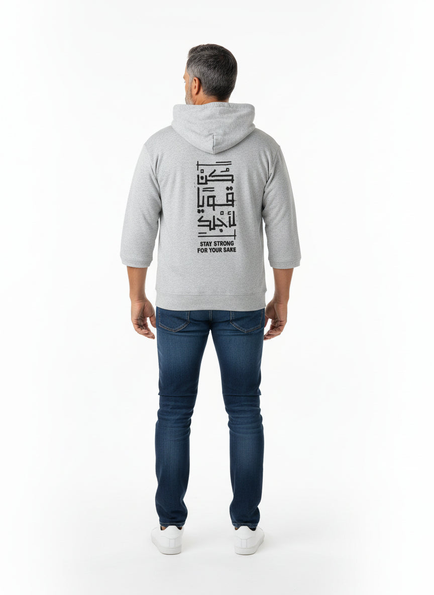 Person wearing a gray hoodie with text on the back, standing against a white background. Antler, Monza Outlet, Monza Fashion, Shein Outlet  