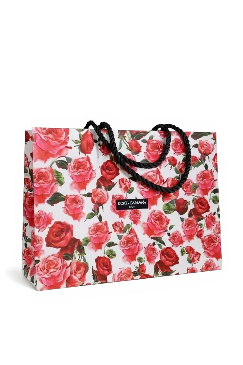 Floral-patterned shopping bag with Dolce & Gabbana logo on a white background. Dolce & Gabbana, Monza Outlet, Monza Fashion, Shein Outlet