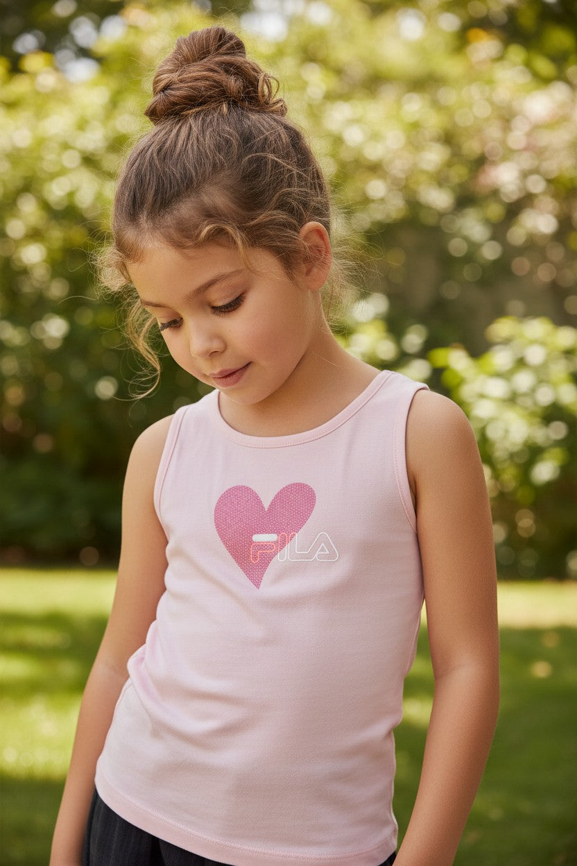 Young girl wearing a pink tank top with a heart design outdoors. Fila, Monza Outlet, Monza Fashion, Shein Outlet