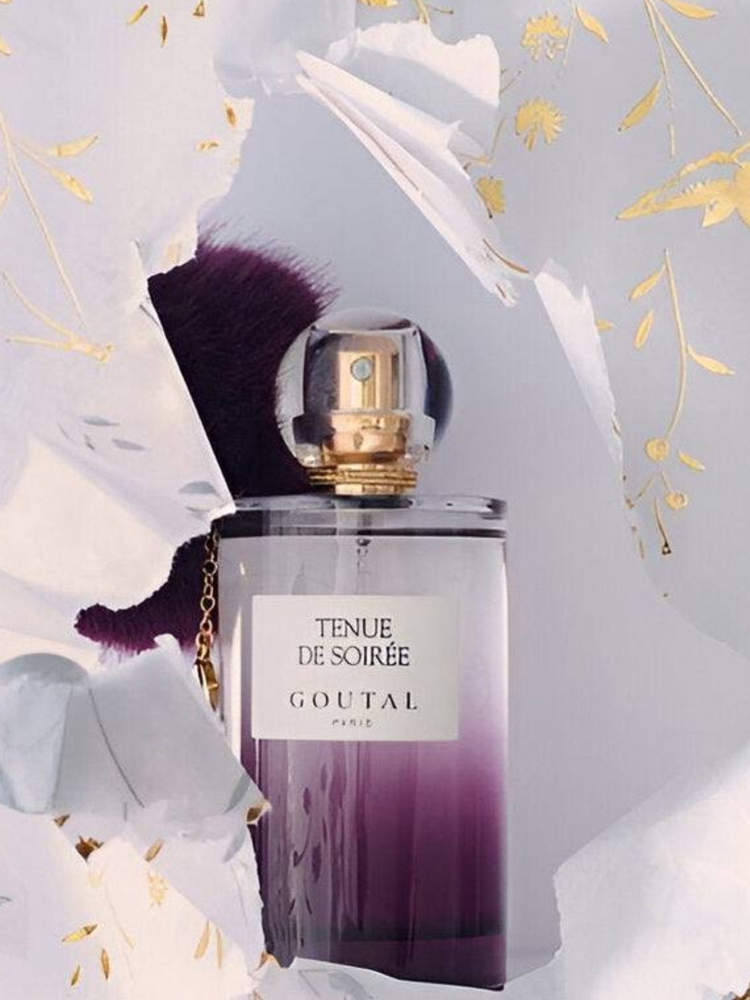 Perfume bottle with gold cap and 'Tenue de Soirée Goutal' label on a decorative background. Goutal, Monza Outlet, Monza Fashion, Shein Outlet